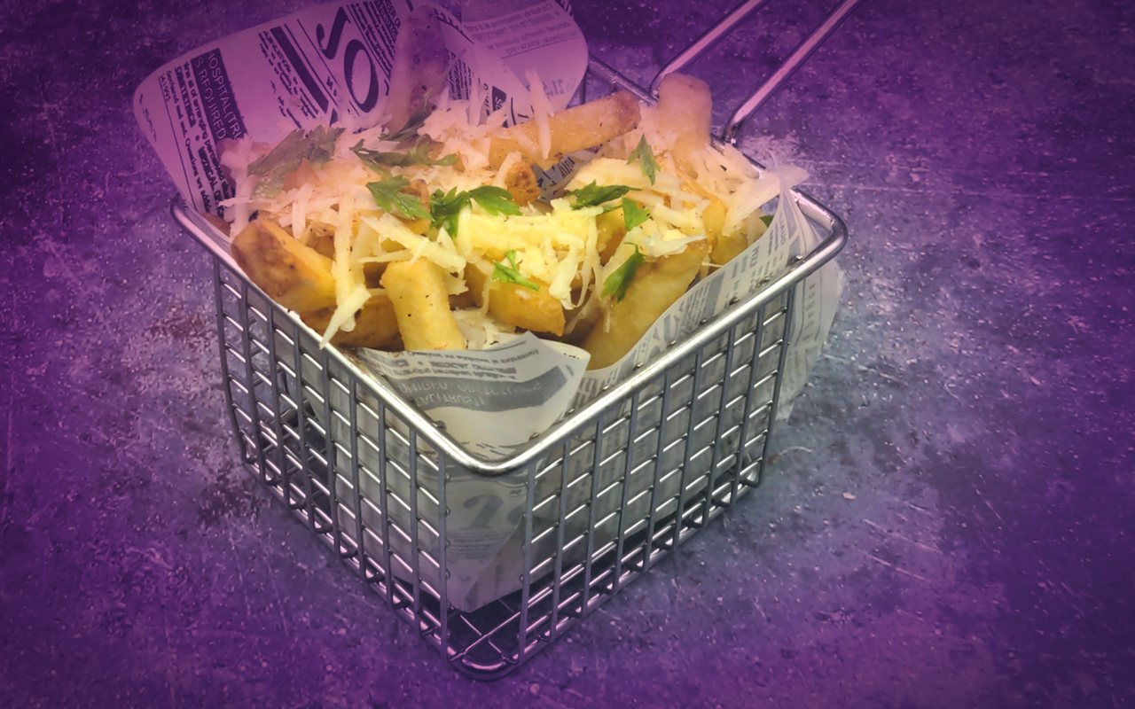Super crispy fries with parmesan in a wire basket